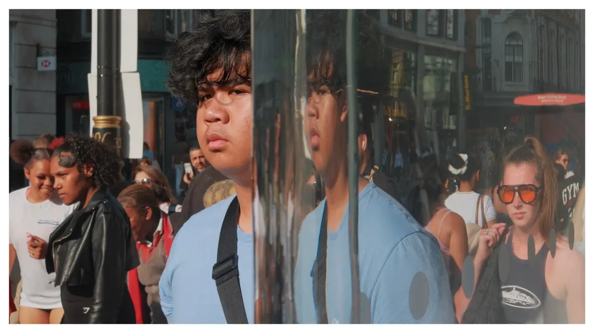 Oxford Street crowds and a shopfront reflection